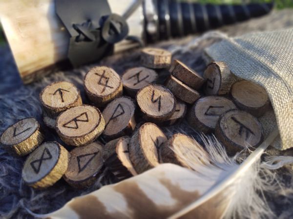 wooden runes and a feather quill